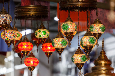 Illuminated lanterns hanging in row