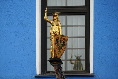 Low angle view of statue against building