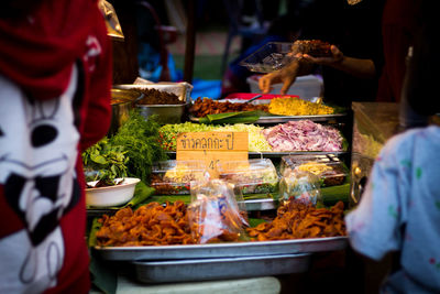 People at market stall for sale
