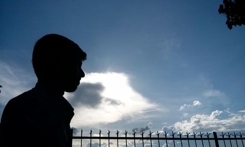 Low angle view of silhouette people against sky