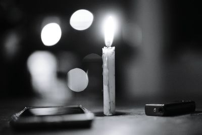 Close-up of illuminated candles on table