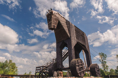 Low angle view of the trojan horse against cloudy sky