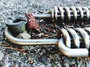 Close-up of rusty chain on ground