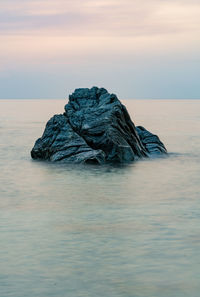 Stone in the water taken by long  exposure at sunset time 