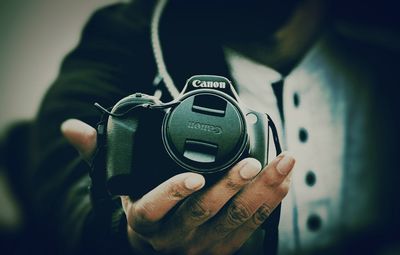 Close-up of hand holding camera