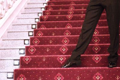 Low section of man walking on staircase