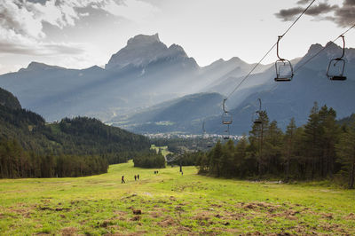 Scenic view of field and mountains against sky