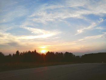 Scenic view of landscape against sky at sunset