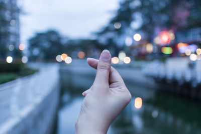 Close-up of hand holding illuminated lighting equipment