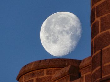 Low angle view of moon against clear sky at night