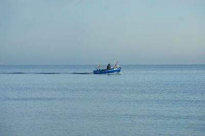 Boat sailing in sea against sky