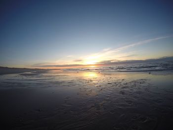 Scenic view of beach against sky during sunset