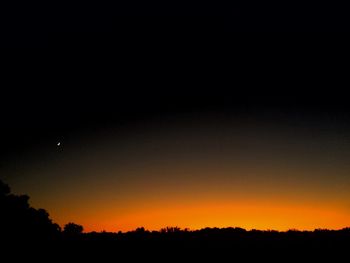 Scenic view of silhouette landscape against sky at night