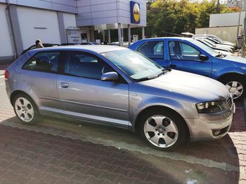 Car parked on street against buildings in city