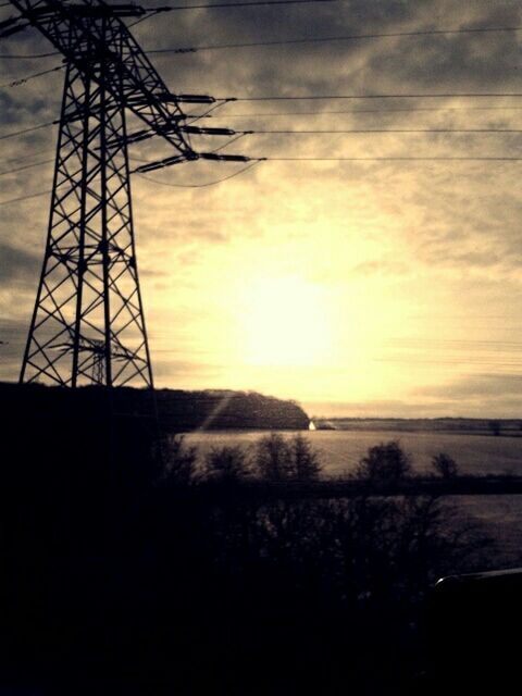 sunset, sky, silhouette, scenics, electricity pylon, cloud - sky, orange color, tranquility, beauty in nature, tranquil scene, fuel and power generation, nature, connection, water, power line, electricity, sea, power supply, idyllic, sun