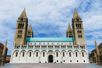 Low angle view of building against cloudy sky