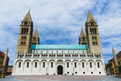 Low angle view of historic cathedral against cloudy sky