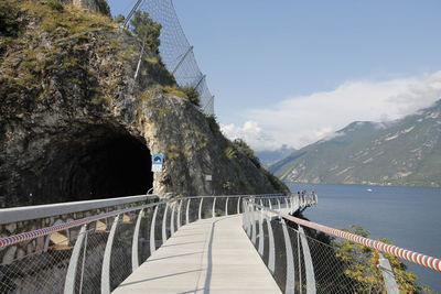 Bridge over mountain against sky