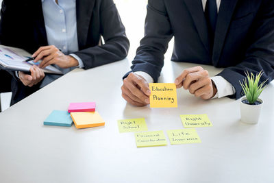 Midsection of business colleagues working at office