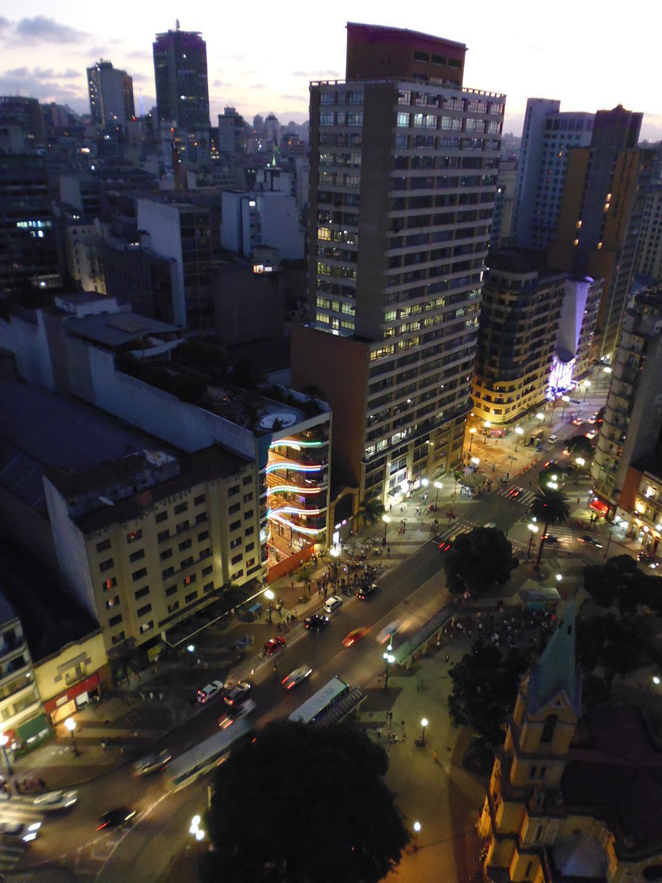 HIGH ANGLE VIEW OF ILLUMINATED CITYSCAPE AGAINST SKY AT NIGHT