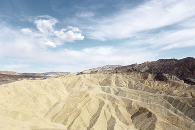 View of desert against cloudy sky