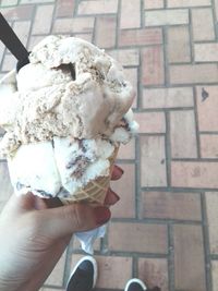 Cropped hand holding ice cream cone