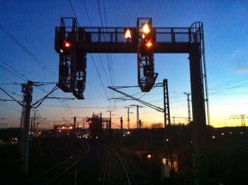 Railroad tracks against sky at dusk