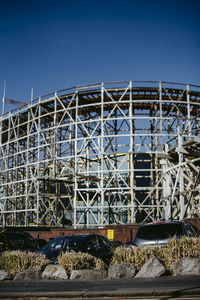 Low angle view of metallic structure against blue sky