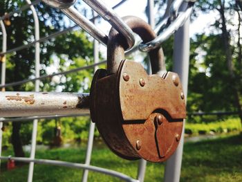 Close-up of padlock on metal fence