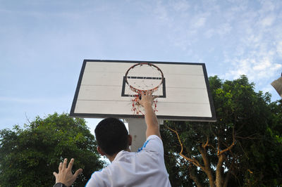 Low angle view of basketball hoop against sky