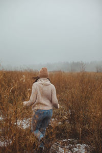 Rear view of woman looking at field