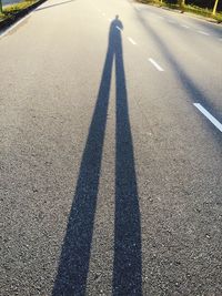 Shadow of man on road