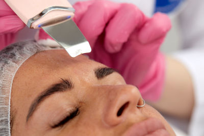 Close-up of young woman holding dental equipment