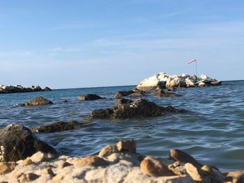 Rocks on beach against sky