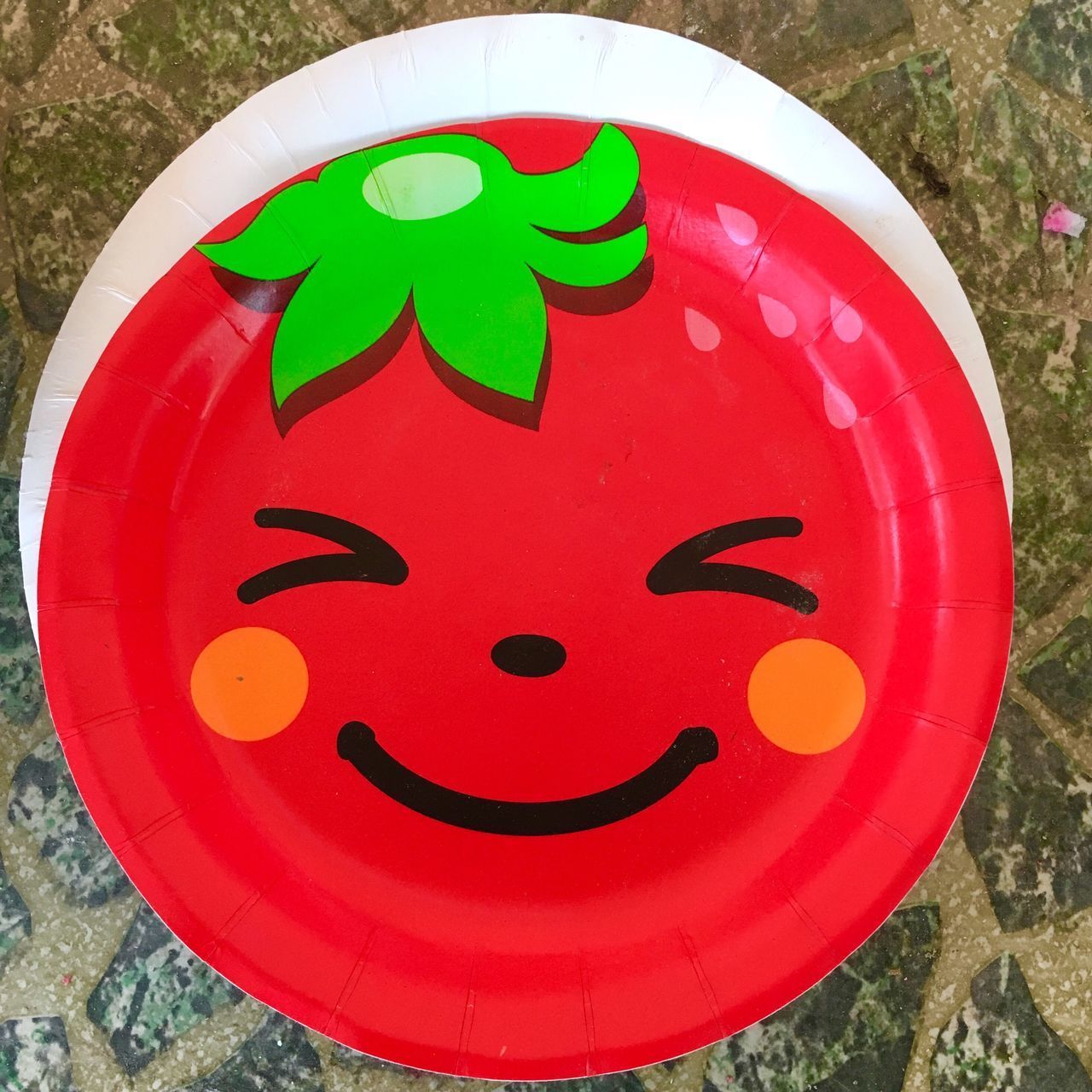 CLOSE-UP OF SMILEY FACE ON RED