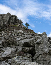 Low angle view of rocky mountains against sky