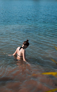 Rear view of young woman in sea