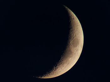 Low angle view of moon against clear sky at night