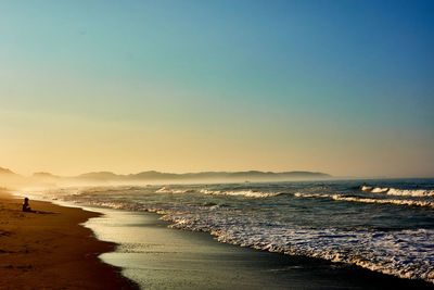 Scenic view of sea against clear sky during sunset