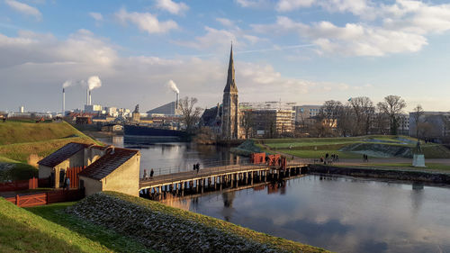 Bridge over river with buildings in background