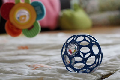 Close-up of multi colored ball on bed