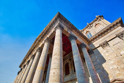 Low angle view of bell tower against blue sky