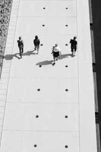 High angle view of people walking on footpath