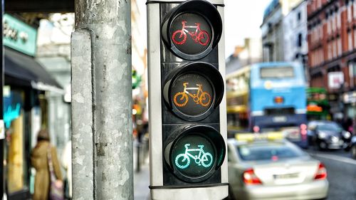 Close-up of traffic lights on street in city