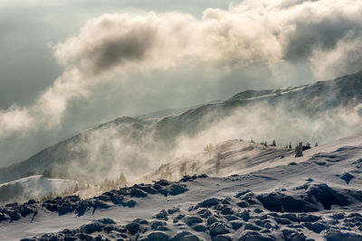 Scenic view of snow covered mountains against sky