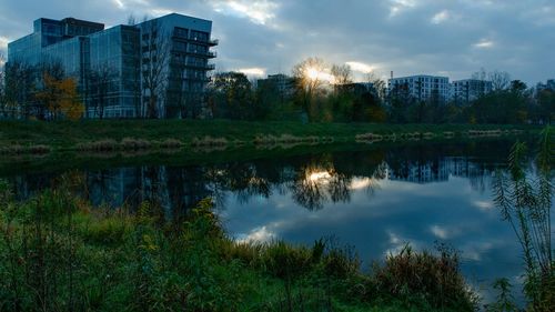 Reflection of trees and buildings in lake