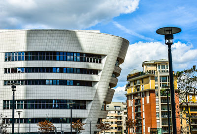 Low angle view of buildings against cloudy sky