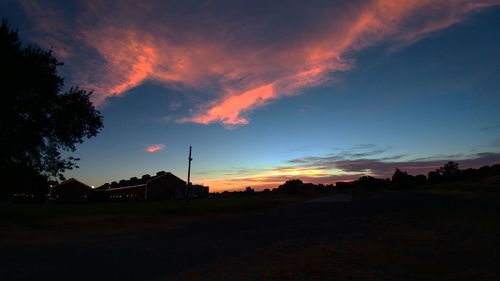 Scenic view of silhouette trees against sky at sunset