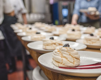 Close-up of dessert served in plates on table at commercial kitchen