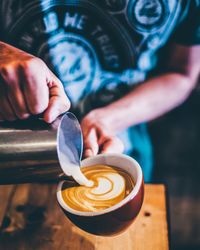 Close-up of hand holding coffee cup